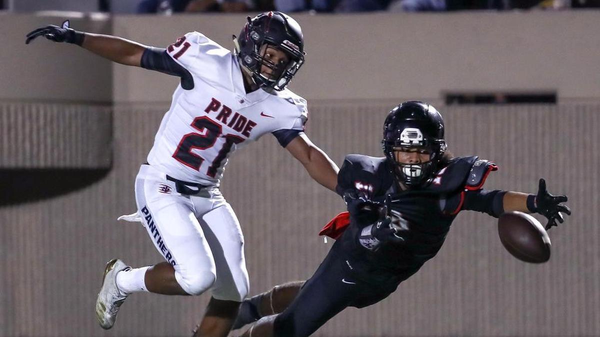 Trinity wide receiver Keanu Hill (18) reaches out for a pass against Colleyville Heritage defensive back Bruce Cobb (21) in September.