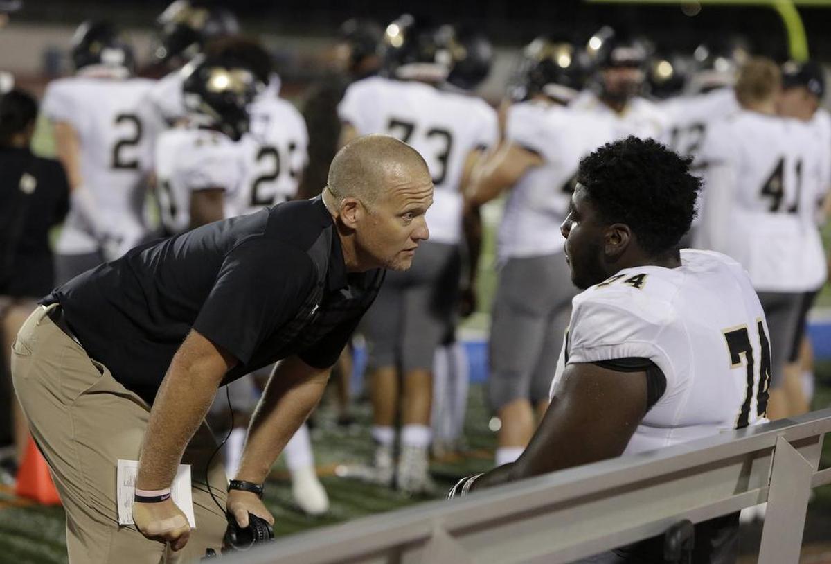 Mansfield head coach Daniel Maberry with Tigers offensive lineman Willis Patrick (74) during the Arlington High game, Oct. 6, 2017.