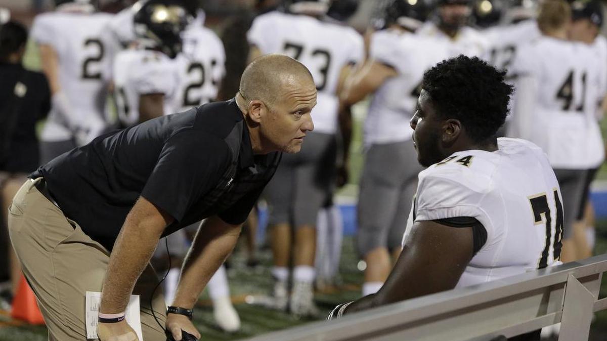 Mansfield head coach Daniel Maberry with Tigers offensive lineman Willis Patrick (74) during the Arlington High game, Oct. 6, 2017.