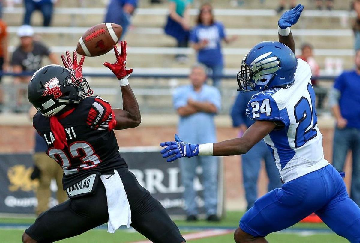Mansfield Legacy wide receiver Ife Adeyi (23) eyes the ball on a 64-yard touchdown reception against North Forney defensive back Derick Holt (24).