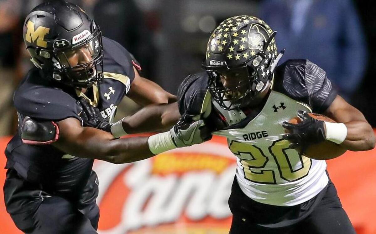Keller Fossil Ridge running back Anthony Smith (20) tries to get past Mansfield linebacker Imioan James, in a 6A playoff game at Newsom Stadium in Mansfield.
