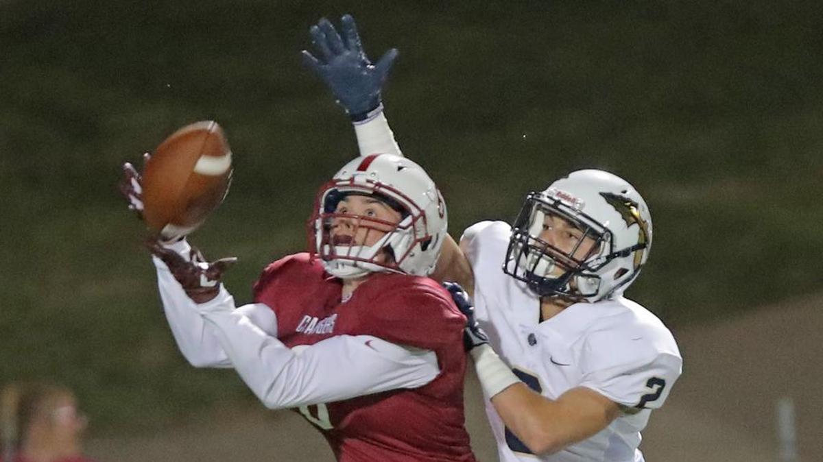 Keller Central defensive back Noah Moreno intercepts a pass intended for Keller receiver Damon Smith.