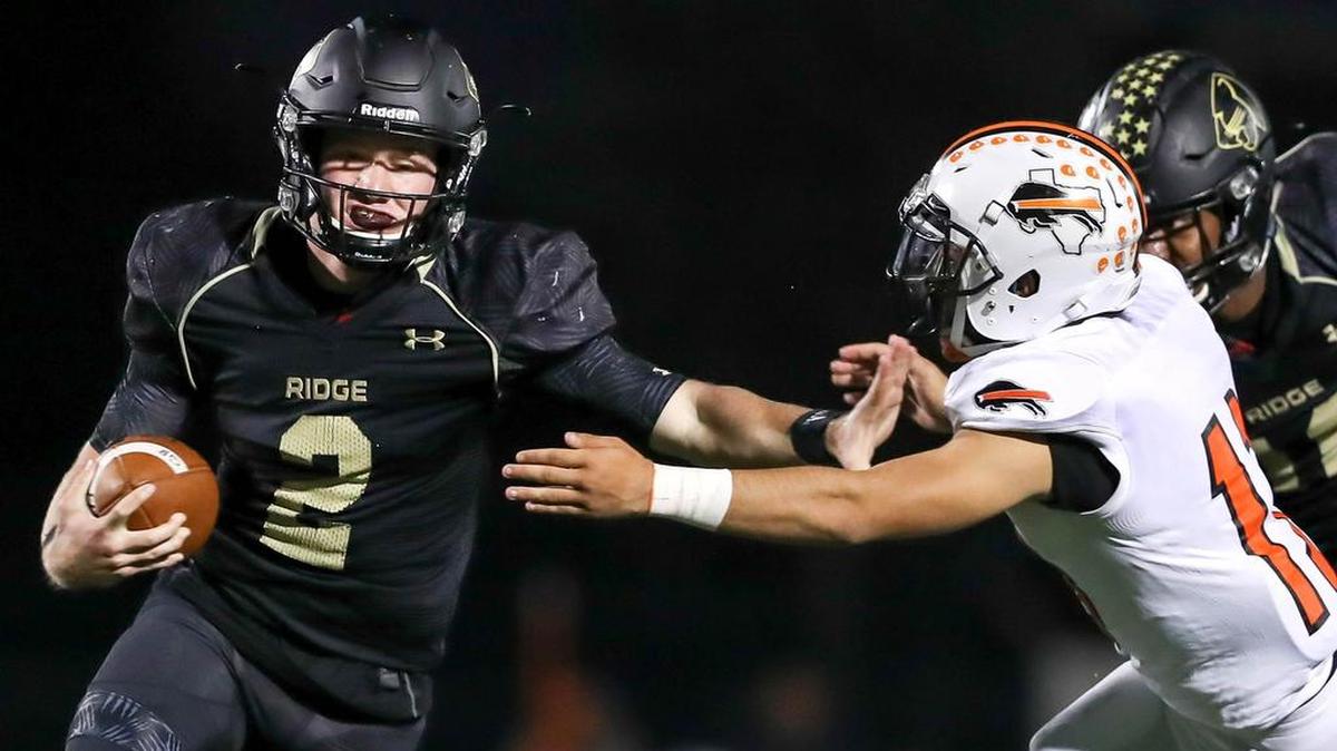 Keller Fossil Ridge quarterback Cobe Craft (2) tries to elude Haltom linebacker Joe Garcia.