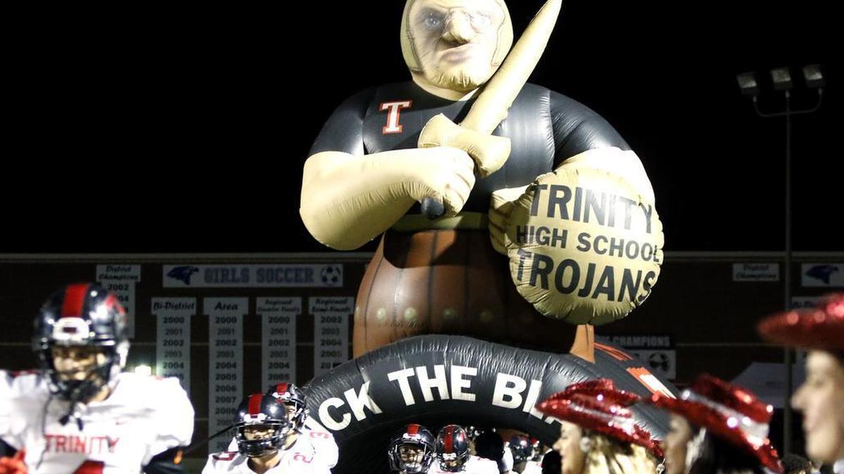 The Trojans take the field for the start of their game against Hebron in high school football at Hawk Stadium Friday October 27, 2017. The score was knotted 14 at the half.
