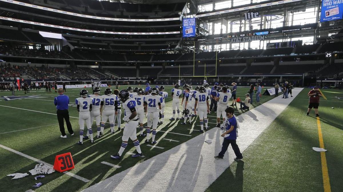 The Balmorhea six-man team watches from the bench area of the smaller regulation field at AT&T Stadium.