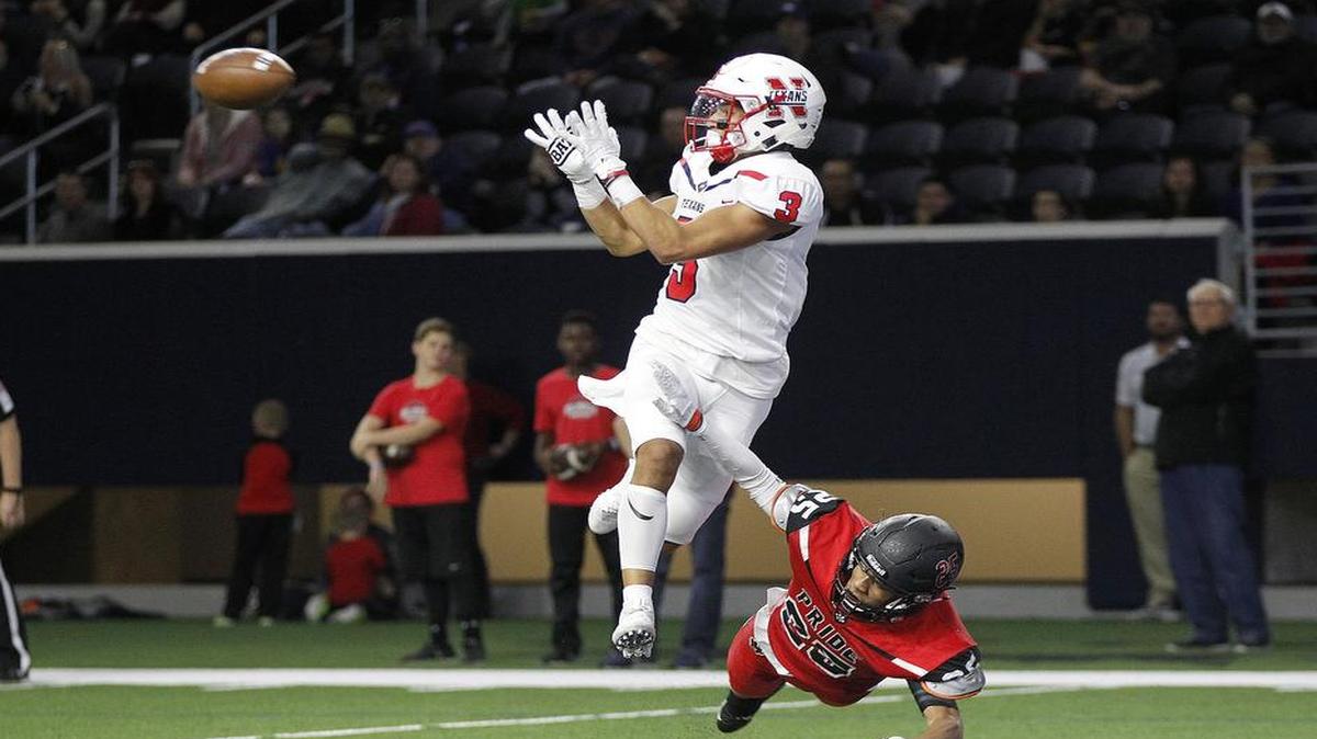 Northwest senior receiver Gavin Holmes goes after a pass defended by Colleyville Heritage junior cornerback Marcus Mosley in the area round of a 5A Division I playoff game at The Star in Frisco on Saturday, November 19, 2016.