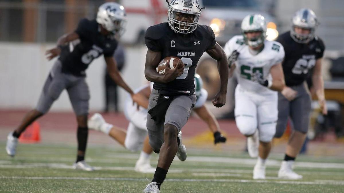 Arlington Martin quarterback back Juma Otoviano (8) breaks free for a long run against Southlake Carroll at UTA’s Maverick Stadium.