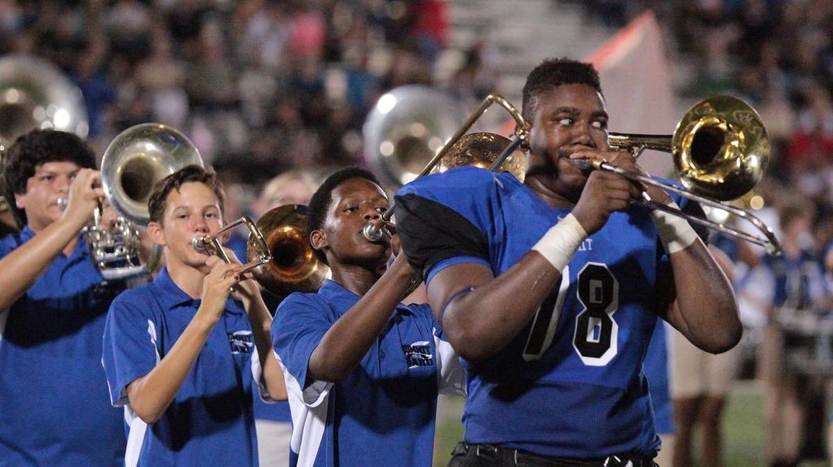 Mansfield Summit’s X'Zavea Gadlin (78) plays trombone with the marching band during halftime during a game in his sophomore year.