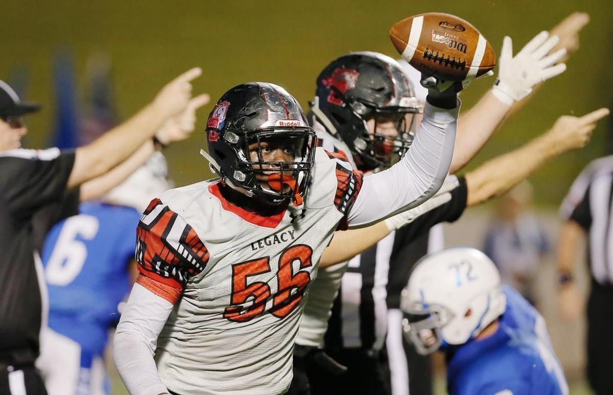 Mansfield Legacy defensive lineman Taurean Carter celebrates recovering a Midlothian fumble during the first half.