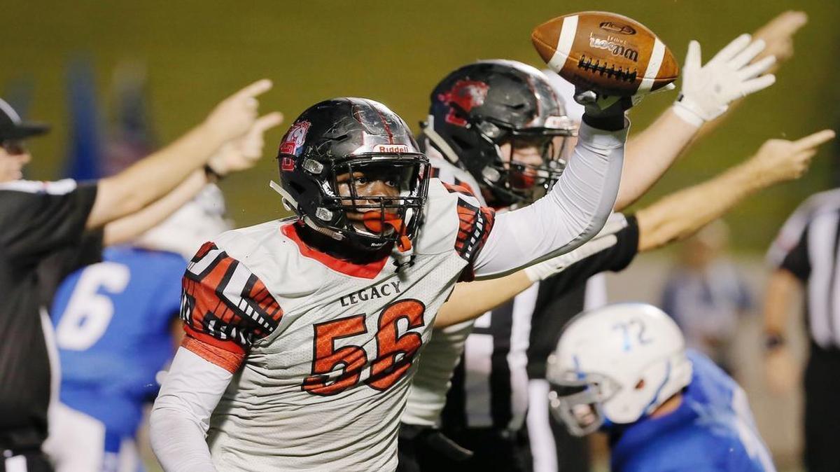 Mansfield Legacy defensive lineman Taurean Carter celebrates recovering a Midlothian fumble during the first half.