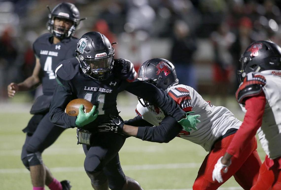 Mansfield Lake Ridge Eagles running back Dewone Jackson (11) rushes against Mansfield Legacy Broncos James Johnson (48).