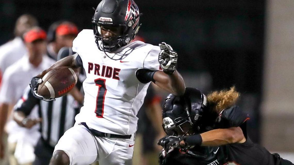 Colleyville Heritage wide receiver Ke'von Ahmad (1) scoots down the sideline against Trinity defensive back Sebastian Tauaalo (32) during the 1st half Friday night, September 15, 2017 played at Pennington Field in Bedford.