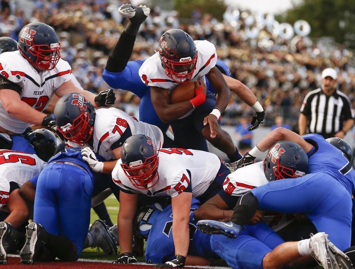 Justin Northwest running back Demareus Hosey (4) drives across the goal line for a touchdown against Trophy Club Nelson at Northwest ISD Stadium, Friday, Sept. 15, 2017.