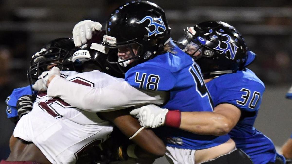 Lewisville’s Kwame Mickels (22) is swarmed for a loss by, from left, Nelson’s Joseph Herrera, Jaired Chaberlain (48) and Chance Cover (30) at Northwest ISD Stadium, Oct. 14, 2016.