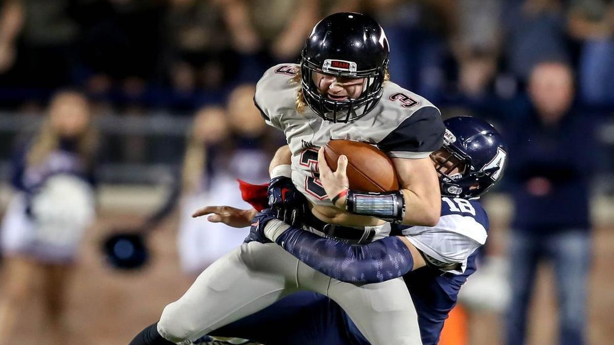 Trinity quarterback Noah Wineteer is sacked by Allen linebacker Jace Waters during the first half of Friday’s Class 6A Division I bi-district playoffs game at Eagle Stadium in Allen.