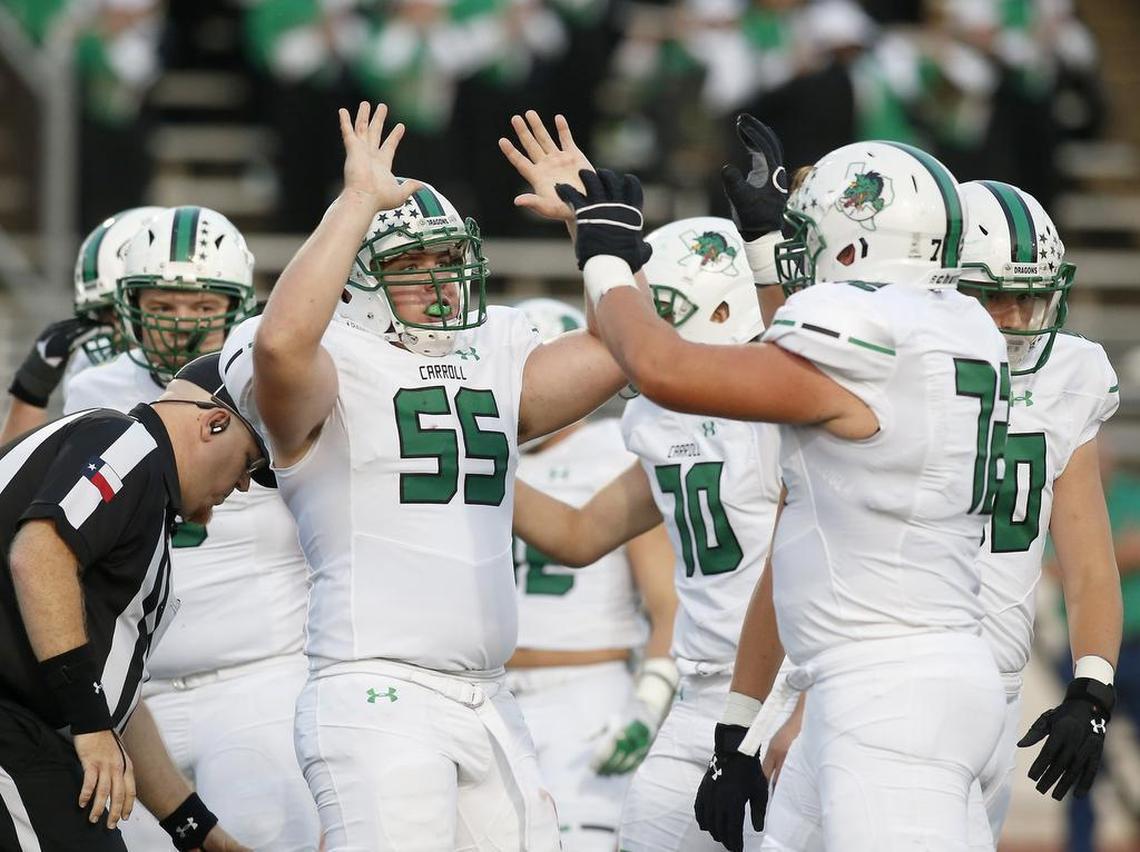 Southlake Carroll’s Matthew Leehan (55) and Jackson Kimble (72) celebrate a touchdown.