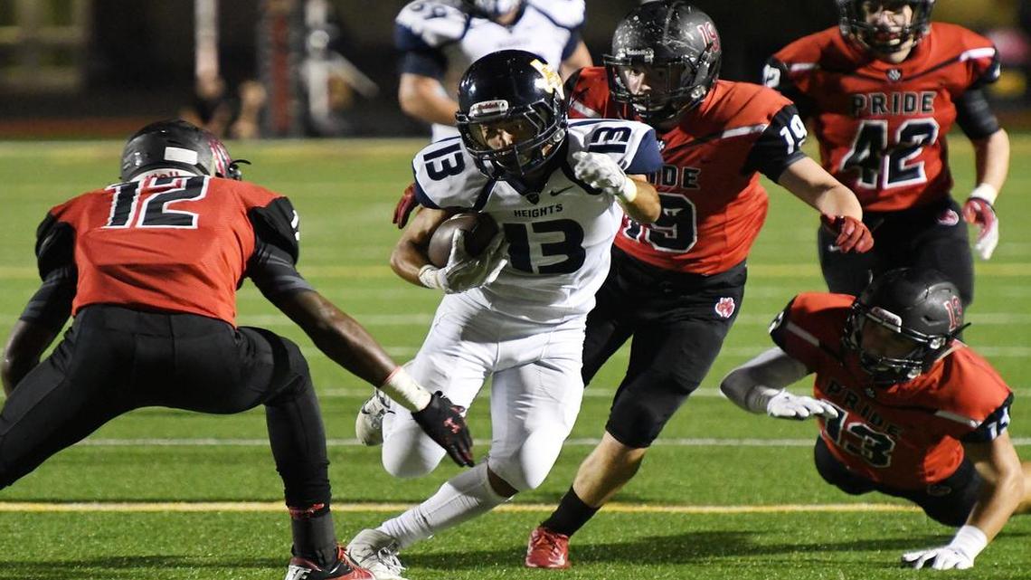 Colleyville Heritage defenders Gervon Thothion (12), Sage Hebb (19) and Caleb Murphy (13) converge on Brian Gonzalez (13) of Arlington Heights, Nov. 10, 2016.