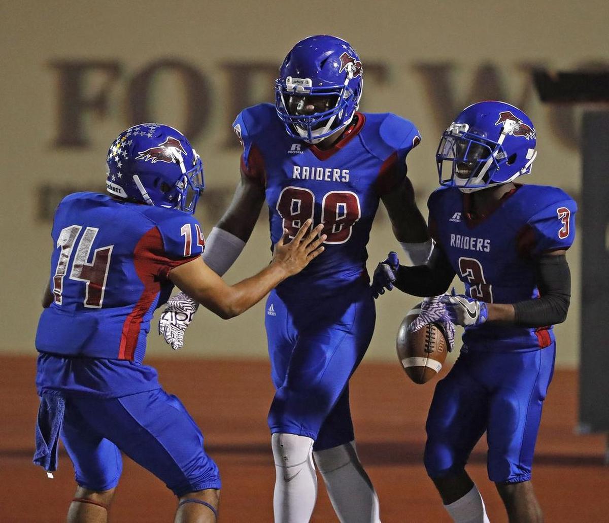 Southwest players Octavio Martinez (14), Nnamdi Adim-Madumere and Daquinn Sullivan (3) celebrate a touchdown in Week 7 action against YMLA.