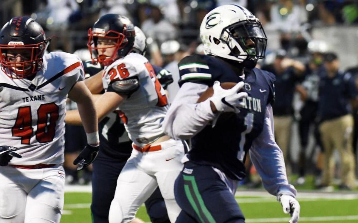 Eaton’s Titus Swen, right, runs into the end zone for a touchdown for a 7-7 tie with Northwest in the first quarter.