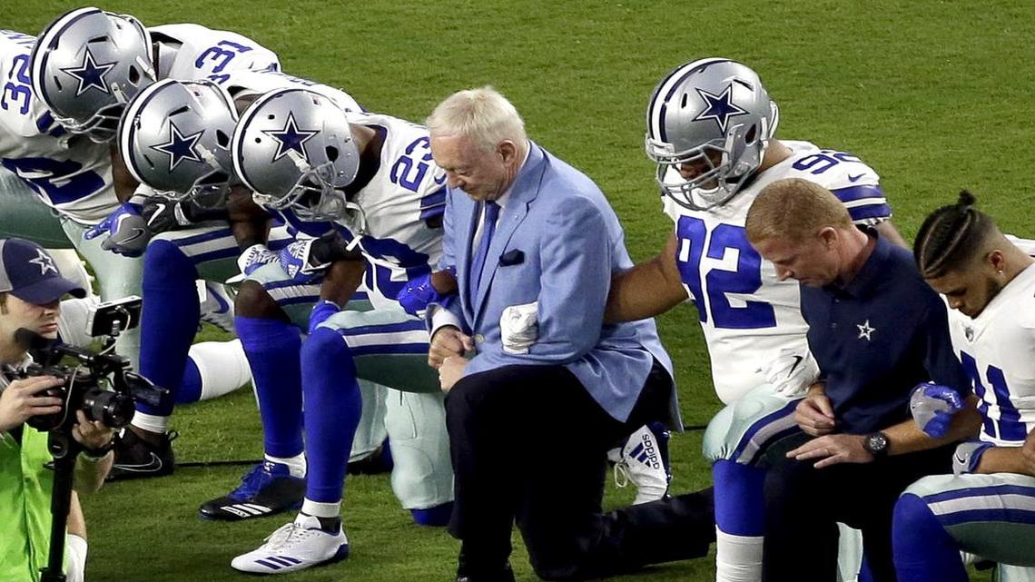 In this Monday, Sept. 25, 2017, file photo, the Dallas Cowboys, led by owner Jerry Jones, center, take a knee prior to the national anthem before an NFL football game against the Arizona Cardinals in Glendale, Arizona.