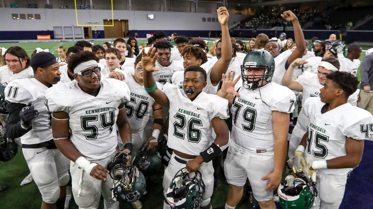Kennedale players celebrate a 63-36 playoff win against Kaufman at the Ford Center in Frisco.