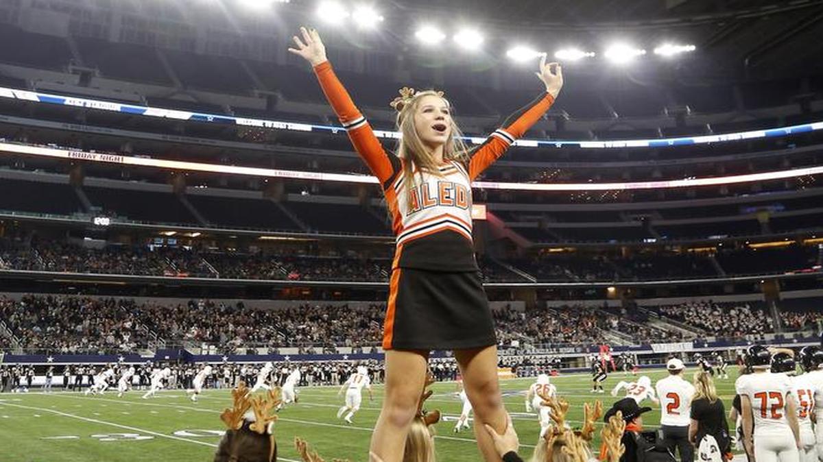 Aledo Bearcats cheerleaders perform in the first half of high school football playoff action against the Randall Raiders at AT&T Stadium in Arlington, Texas Saturday, Dec. 5 2015.