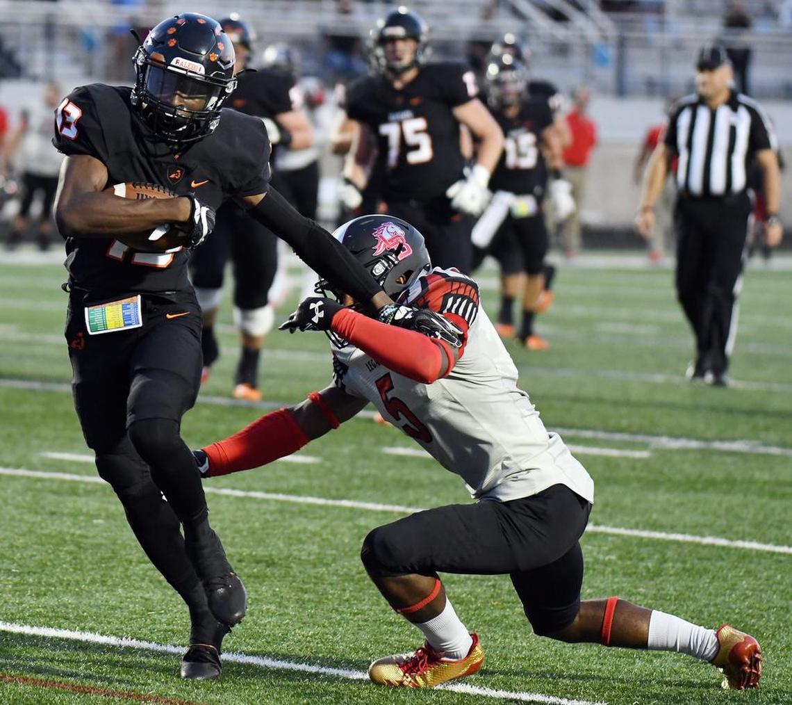 Aledo’s Money Parks, left, races away from Legacy’s Jalen Catalon for a first down in the first quarter.