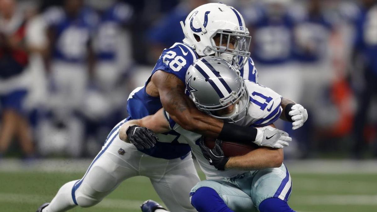 Dallas Cowboys wide receiver Cole Beasley is brought down by Indianapolis Colts cornerback Tevin Mitchel during Saturday’s game at AT&T Stadium. Mitchel is a graduate of Mansfield Legacy High School. Dallas won the game 24-19.