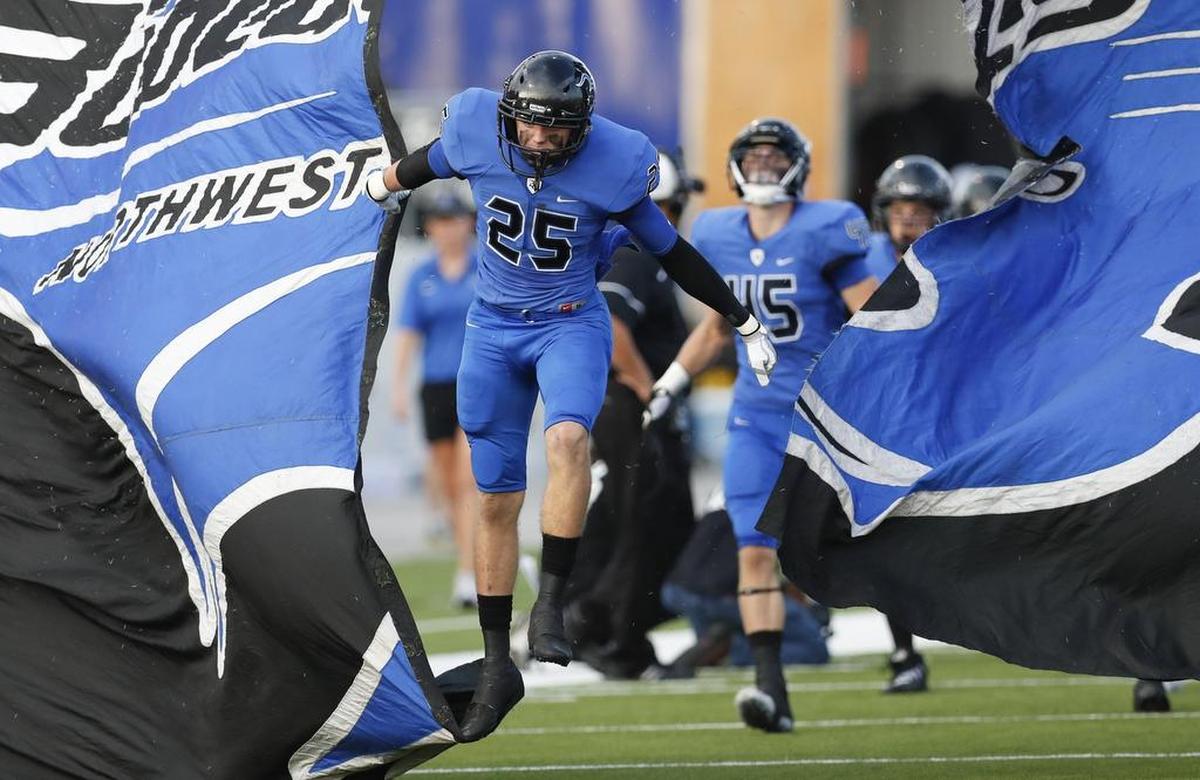 Byron Nelson Keaton Shedden (25) leads his teammates onto the field during a high school football game in September.