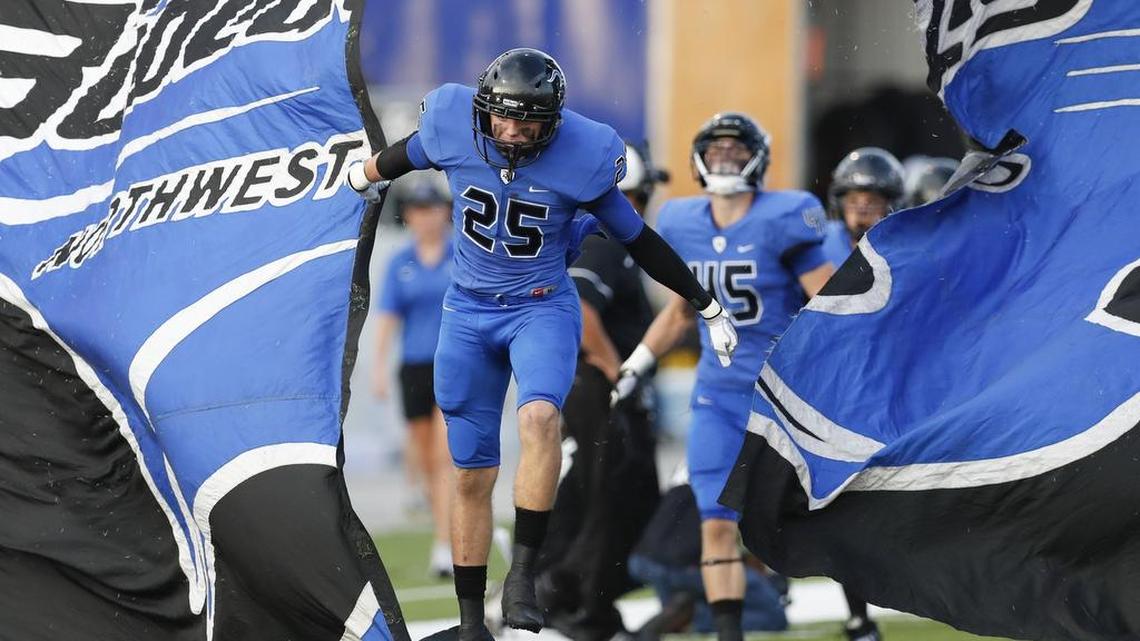 Byron Nelson Keaton Shedden (25) leads his teammates onto the field during a high school football game in September.