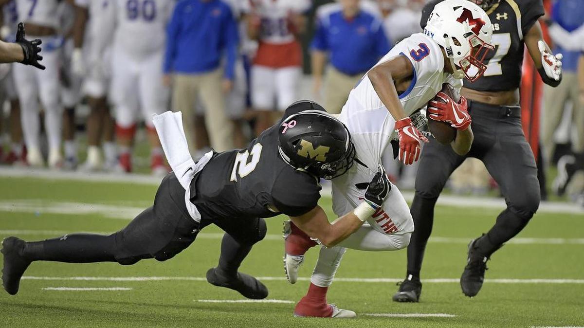 Midway Panthers wide receiver D'ante Thomas (3) is brought down by Mansfield Tigers Corbin Frederick (2) during the first quarter as Mansfield plays Waco Midway at the McLane Stadium in Waco, TX, Friday, Dec. 1, 2017.
