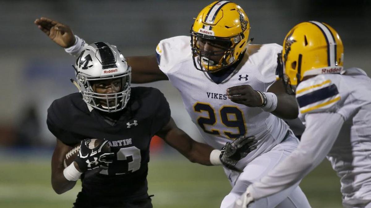 Arlington Martin running back Montrell Smith (13) is caught from behind by Arlington Lamar defensive lineman Bobby Brown (29) at Maverick Stadium in Arlington, Nov. 9, 2017.