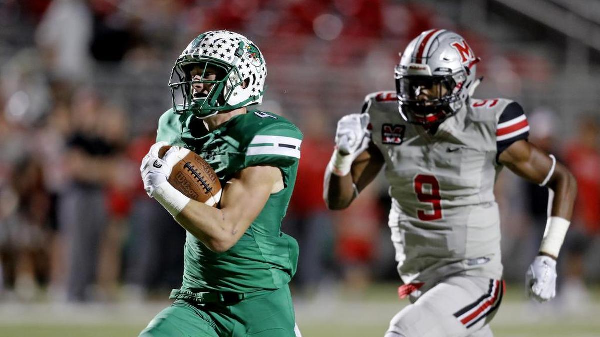 T.J. McDaniel is chased by Marcus linebacker Marcel Brooks (9) to the end zone for Carroll's first touchdown.