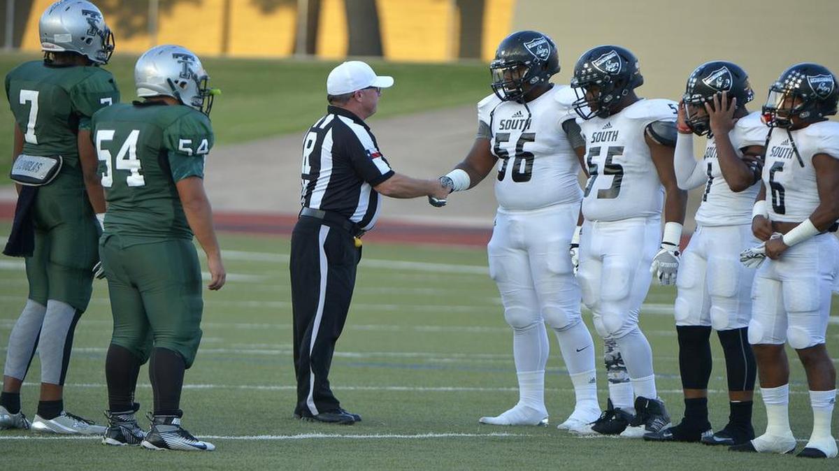 Team captains meet for the coin flip before the game as South Hills Scorpions play Trimble Tech at Farrington Field, Sept. 22, 2016.