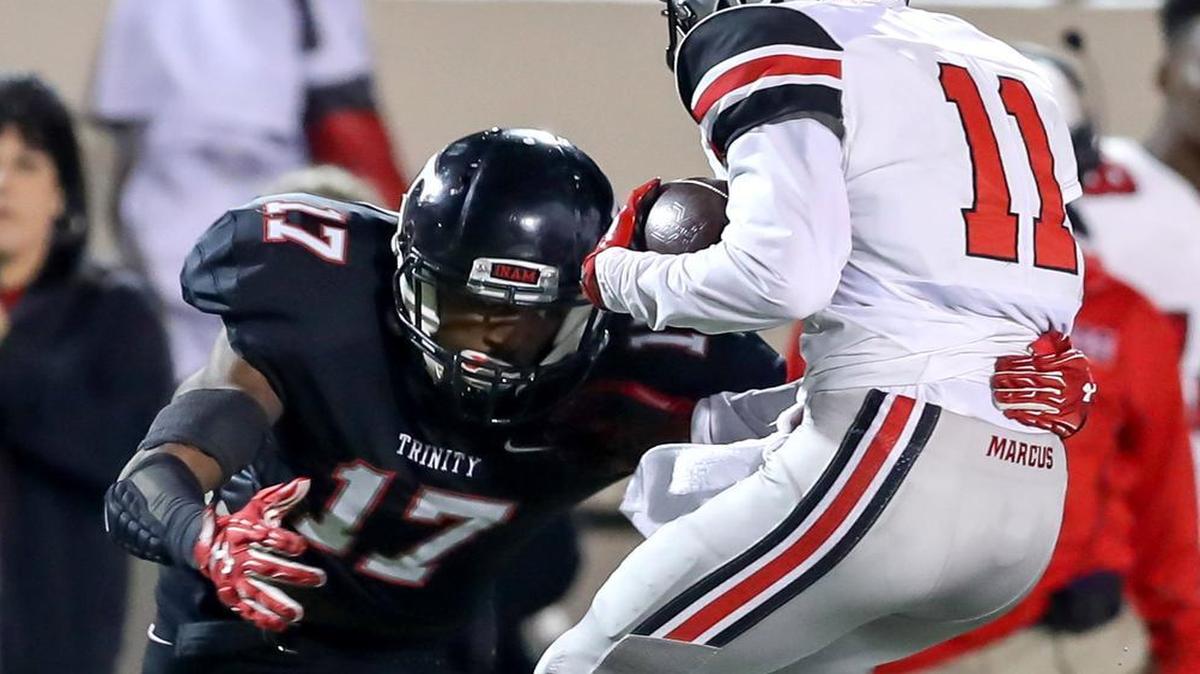 Trinity DB Cam’ron Jones (17) makes the tackle on Flower Mound Marcus WR Blake Covin (11) during the 2nd quarter, Thursday night, November 3, 2016 played at Pennington Field in Bedford.
