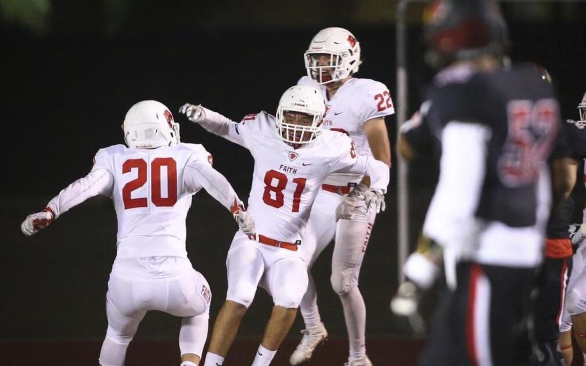 Grapevine Faith players Ethan Fleming (20) and Jake Mitchell (22) celebrate an interception and touchdown by Austin Geiser (81) during the 2016 regular season.