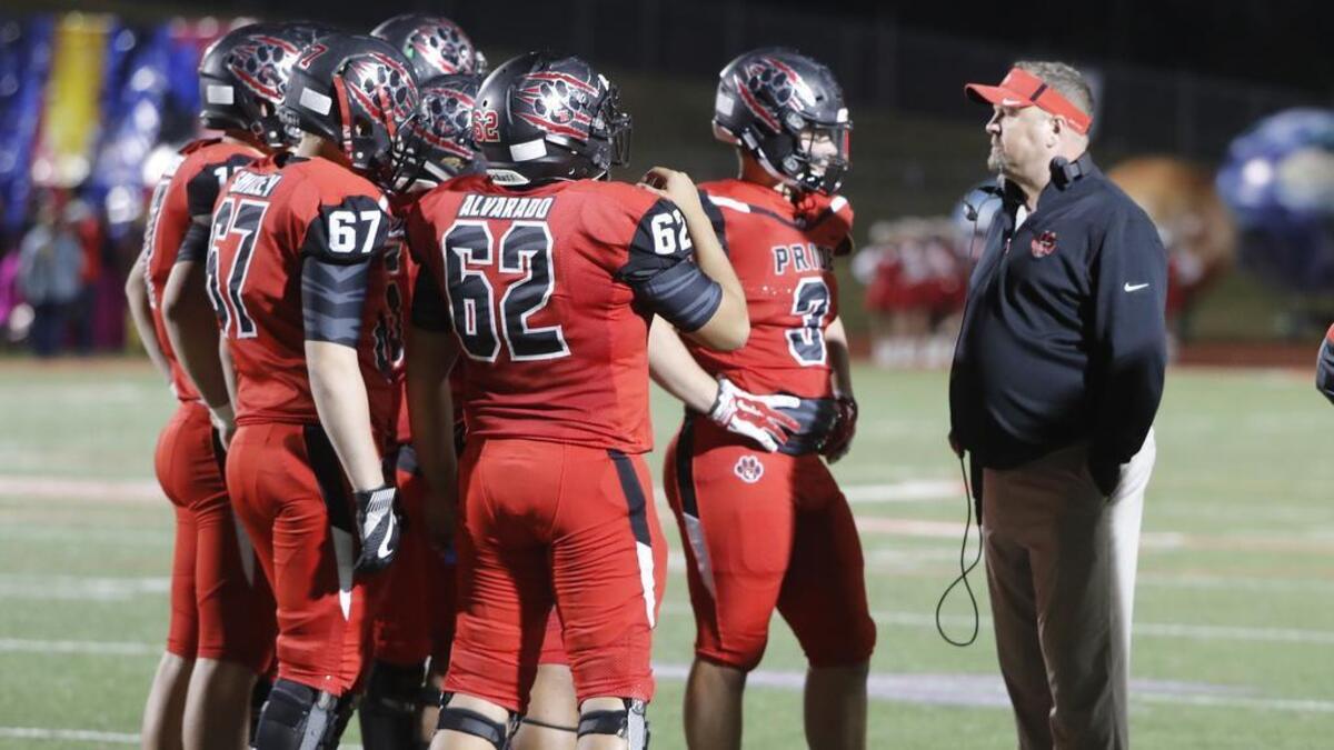 No. 10 in the 5A poll, Colleyville Heritage players confer with head coach Joe Willis during the Richland game, Nov. 10, 2017.