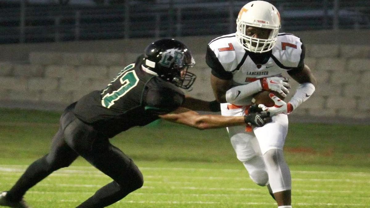 Bryson Jackson (17) of Lake Ridge tackles Spencer Gilbert II (7) of Lancaster in a game Friday, September 18, 2015.