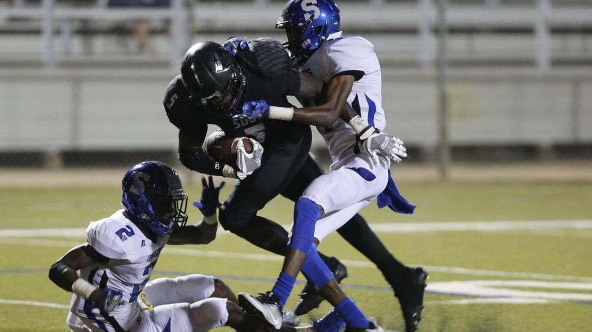 In a Week 1 game against Seagoville, South Hills running back Anthony Watkins fights yards.