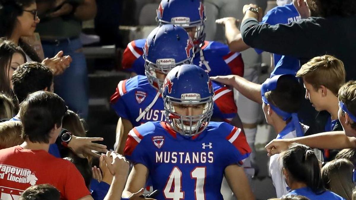 The Grapevine Mustangs enter the field from the stands before the 2016 game against Colleyville Heritage.