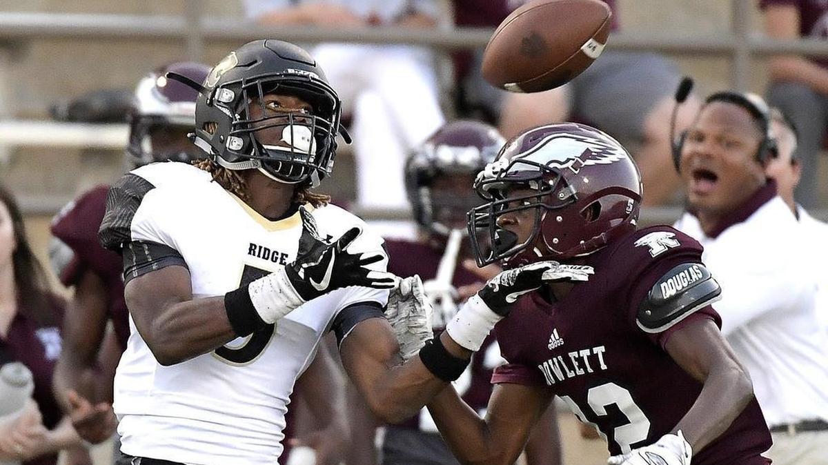 Fossil Ridge wide receiver Stefan Cobbs (5) eyes the ball in front of Rowlett defender Emmitt Seals, Sept. 21, 2017.