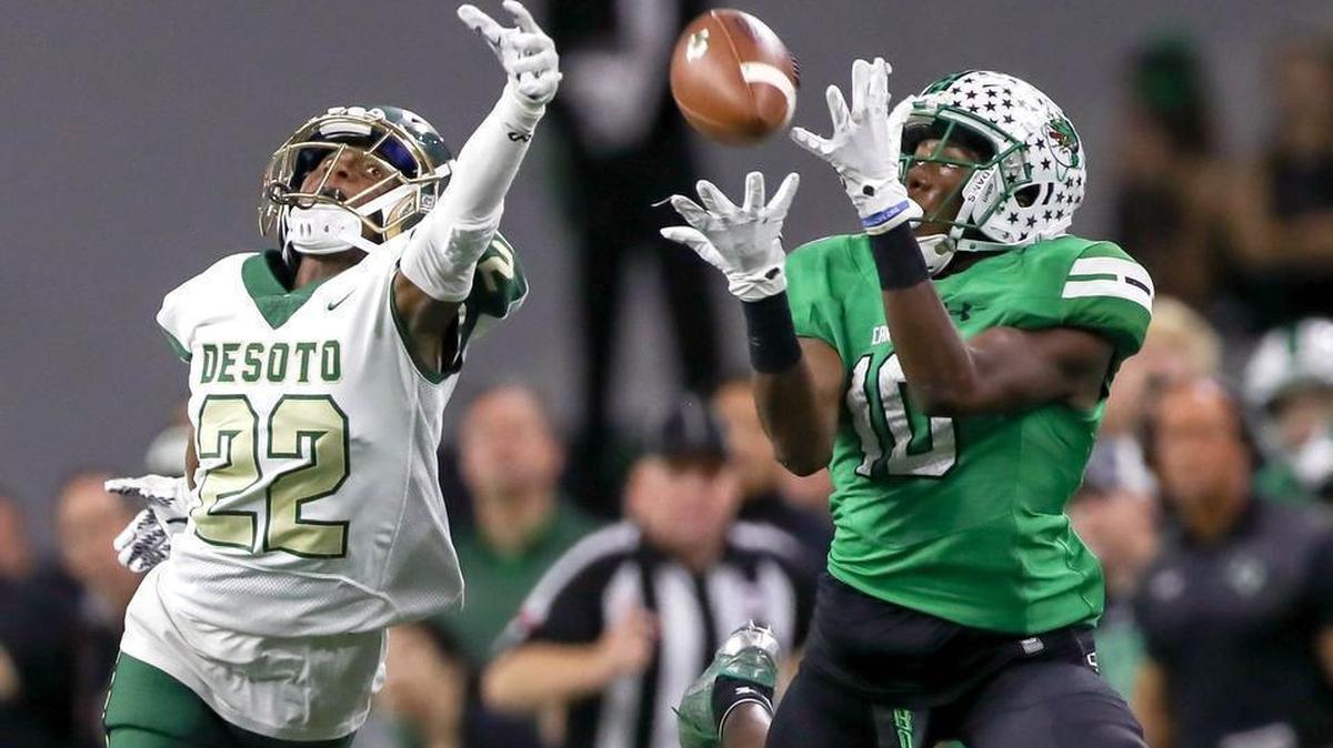 Southlake Carroll wide receiver R.J. Mickens (10) eyes the ball past DeSoto defensive back Jabbar Muhammad.