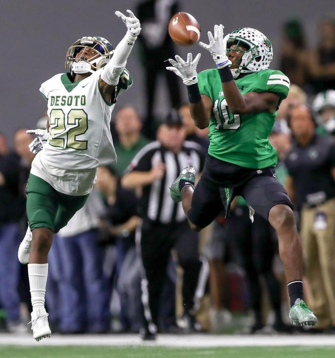 Southlake Carroll’s RJ Mickens (right) catches a pass against DeSoto in the 2017 area round.