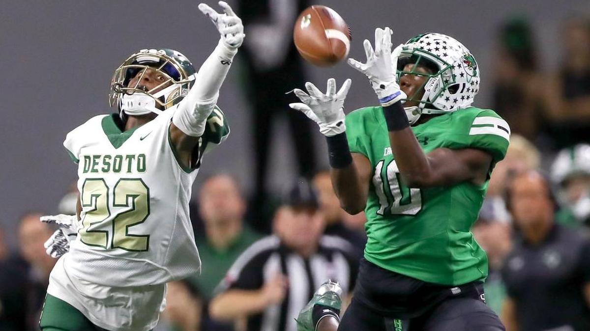 Southlake Carroll’s RJ Mickens (right) catches a pass against DeSoto in the 2017 area round.