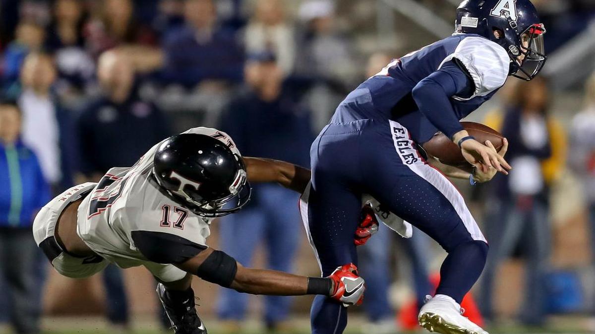Former Euless Trinity DB Cam’ron Jones (17) tries to make the stop on Allen QB Mitchell Jonke (R) during the first half of Friday night’s 6A Division I, Bi-district football playoffs at Eagle Stadium in Allen, TX.