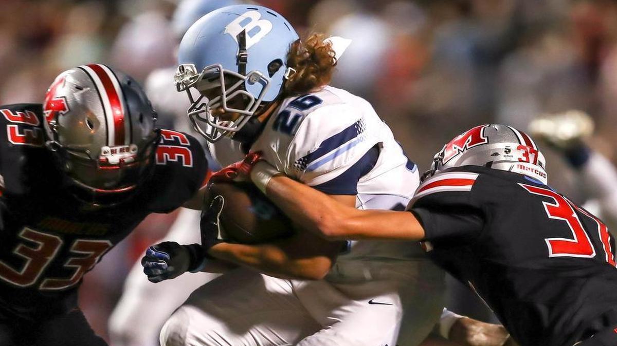 L.D. Bell running back Terry Pace is brought down by Marcus’ Brenden Griner.