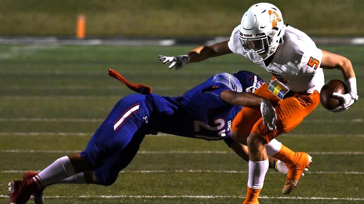 Hunter Rosson (5) is tackled by Cooper’s Izac Faraci in their regional round contest.