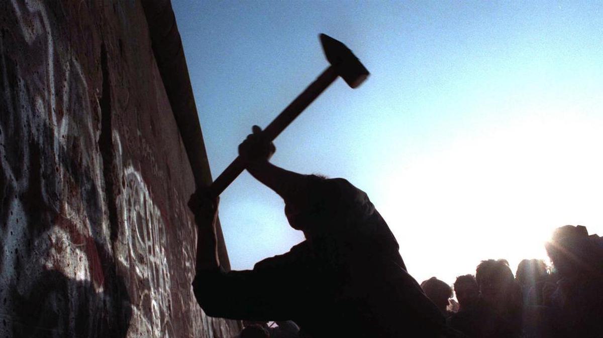 A man hammering at the Berlin Wall in 1989, the last time Grand Prairie made the playoffs.