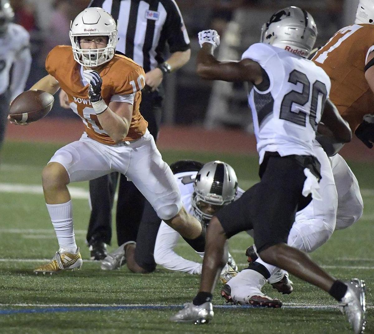 Bowie Volunteers Ty DeArman (10) scrambles to pick a a first down as Arlington Martin plays Arlington Bowie on Sept. 29, 2017.