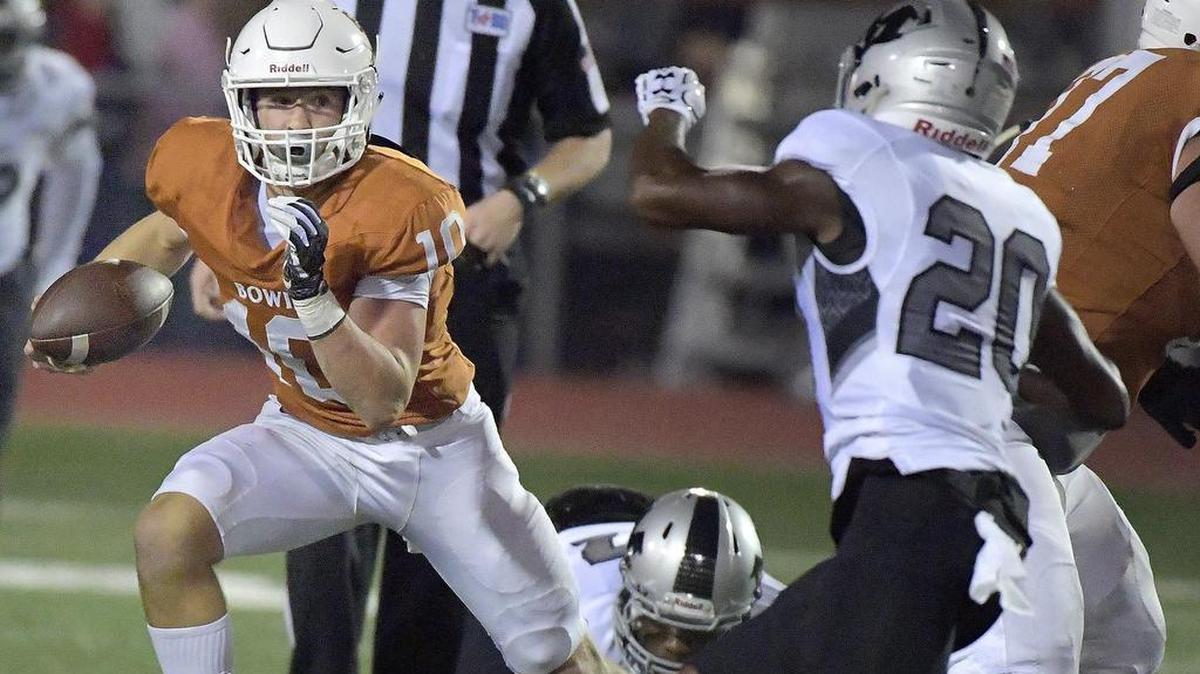 Bowie Volunteers Ty DeArman (10) scrambles to pick a a first down as Arlington Martin plays Arlington Bowie on Sept. 29, 2017.
